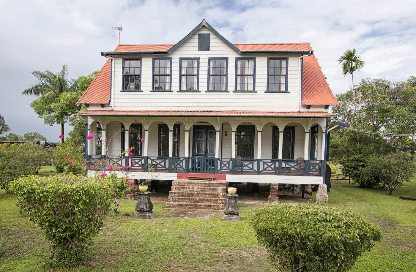 The restored plantation house of Frederiksdorp with its veranda and orange roof.